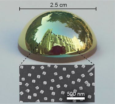 A curved optical surface is covered with a coating that absorbs all red light, giving the surface a green tint. The surface is covered with 100 nm silver cubes (inset).