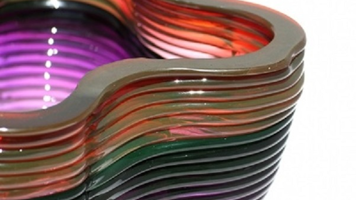 The ability to introduce variations in color into the stream of molten glass is one of the unusual properties of the new 3D glass printing system from MIT. (Image credit: Chikara Inamura)