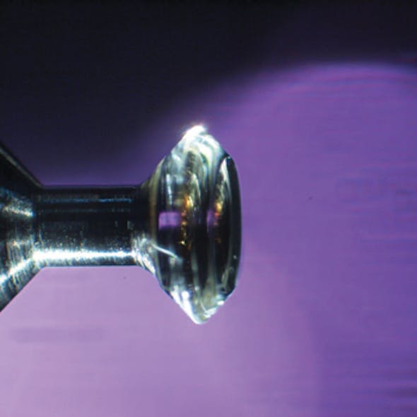 FIGURE 1. In this whispering-gallery-mode (WGM) resonator, the 3 mm resonator is shown placed on a holding pin.