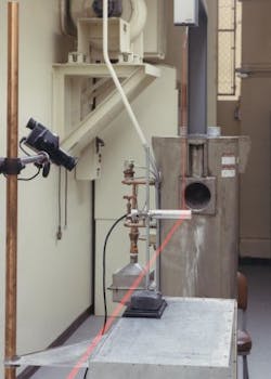 A quantum-cascade laser (QCL) in a plastic box (mounted to the post) is aligned to a cobalt-60 gamma-radiation source at PNNL&rsquo;s High Exposure Facility. Positioning lasers aid the initial setup and cameras are positioned to remotely monitor instrument readings during irradiation.