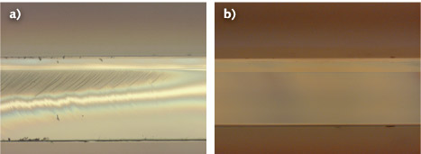 Cross sections of 0.7-mm-thick Corning CT24 glass are taken with a Nomarski differential interference contrast microscope. The piece cut with a CO2 laser shows residual stress (a), while the cut produced with the CO laser is defect-free (b).