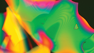 A dielectric multilayer stack coating, measuring 0.5 &mu;m in total thickness, that has been intentionally released from the optic surface before imaging. The image was taken at 200x using a Nomarski microscope.