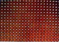 Part of a sample shows 8µm holes that are produced, using a solid-state UV laser, in polyimide at a pitch of 25 µm. The sample is 1mm x 1mm and contains 1600 holes, drilled at once with the mask technique. Part of a sample shows 8µm holes that are produced, using a solid-state UV laser, in polyimide at a pitch of 25 µm. The sample is 1mm x 1mm and contains 1600 holes, drilled at once with the mask technique.