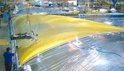 North Sails’ technicians inspect a 3DL sail on a custom mold. North Sails’ technicians inspect a 3DL sail on a custom mold.