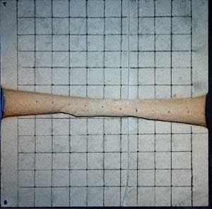 Cross section of lased tunnel 12 inches across measuring 2.0 inches in diameter on each end.