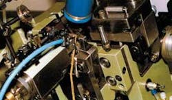 FIGURE 1. A laser welder is coupled with a high-speed chain making machine. FIGURE 1. A laser welder is coupled with a high-speed chain making machine.