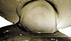 FIGURE 4. The close up photo of a welded pendant chain link shows the small dimensions. FIGURE 4. The close up photo of a welded pendant chain link shows the small dimensions.