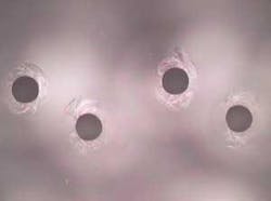 FIGURE 1. Exit holes in borosilicate glass drilled with excimer laser. FIGURE 1. Exit holes in borosilicate glass drilled with excimer laser.