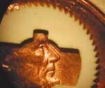 A gear cut in plastic, compared to a penny. A gear cut in plastic, compared to a penny.