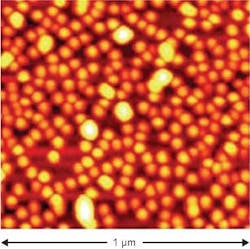 FIGURE 1. Self-assembled InGaAs quantum dots are arranged randomly and vary in size in this micrograph of an area 1 µm wide. FIGURE 1. Self-assembled InGaAs quantum dots are arranged randomly and vary in size in this micrograph of an area 1 µm wide.