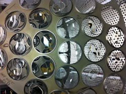 FIGURE 3. Two dome segments of eyeglass lenses are ready for loading into a vacuum coating chamber. FIGURE 3. Two dome segments of eyeglass lenses are ready for loading into a vacuum coating chamber.