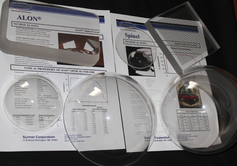 FIGURE 1. Examples of ALON and spinel components produced by Surmet are shown, including a component with a metal grid incorporated into it (upper right).