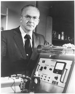 FIGURE 1. Eli Snitzer at American Optical with a large Nd-glass laser rod in September 1964. FIGURE 1. Eli Snitzer at American Optical with a large Nd-glass laser rod in September 1964.