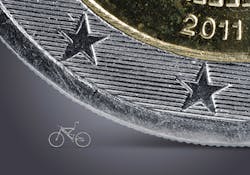 FIGURE 1. Micro bicycle cut with an ultrashort pulse laser, standing next to a 2 Euro coin for size comparison. FIGURE 1. Micro bicycle cut with an ultrashort pulse laser, standing next to a 2 Euro coin for size comparison.