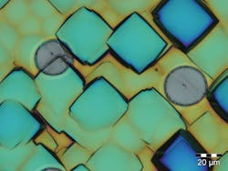 FIGURE 3. A micrograph shows c-Si surface structure after KOH etching. Single-shot femtosecond laser processing (round spots) preserves these structures without melting. FIGURE 3. A micrograph shows c-Si surface structure after KOH etching. Single-shot femtosecond laser processing (round spots) preserves these structures without melting.