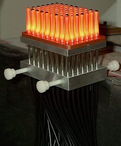 FIGURE 4. A visual inspection station highlights ceramic parts looking for flaws. The parts are illuminated from the inside by a 7 × 9 position fiber-optic matrix array coupled to a single halogen light source. FIGURE 4. A visual inspection station highlights ceramic parts looking for flaws. The parts are illuminated from the inside by a 7 × 9 position fiber-optic matrix array coupled to a single halogen light source.