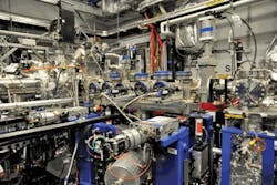 The production chamber in operation, illuminated by the emission of multiple PLD plumes. The production chamber in operation, illuminated by the emission of multiple PLD plumes.