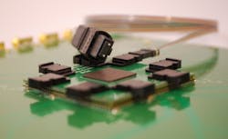 FIGURE 2. Parallel optical-fiber ribbon cable, terminated in multiterminal optical connectors, provides connection either between optical ports of IC packages or to the front panel of the box. FIGURE 2. Parallel optical-fiber ribbon cable, terminated in multiterminal optical connectors, provides connection either between optical ports of IC packages or to the front panel of the box.