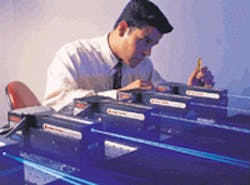 Engineer Randy Hurtado checks out single-frequency DPSS blue microlasers with 400-mW output power. Engineer Randy Hurtado checks out single-frequency DPSS blue microlasers with 400-mW output power.