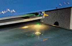 Frequency-doubled Nd:YAG laser scribes a CdTe coating on a 2 x 4-ft glass panel. Frequency-doubled Nd:YAG laser scribes a CdTe coating on a 2 x 4-ft glass panel.