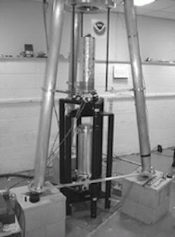 Absolute differential gravimeter consists of two cylindrical vacuum chambers, each within which a retroreflector is dropped. A single laser supplies light to two fiber-coupled interferometers that track the retroreflector positions. The combined signals produce a difference measurement. A 1-ton tungsten mass (part of which can be seen above the instrument) is used for sensitivity testing. Absolute differential gravimeter consists of two cylindrical vacuum chambers, each within which a retroreflector is dropped. A single laser supplies light to two fiber-coupled interferometers that track the retroreflector positions. The combined signals produce a difference measurement. A 1-ton tungsten mass (part of which can be seen above the instrument) is used for sensitivity testing.