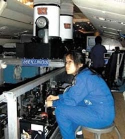 University of Illinois scientist Xinzhao Chu adjusts one of the solid-state lasers comprising the Fe Boltzmann temperature lidar while in flight aboard a research airplane owned by the US National Science Foundation and operated by the National Center for Atmospheric Research.