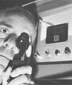 FIGURE 1. In 1965 Honeywell introduced a compact laser retina welder, which could be gripped comfortably, focused, aimed and fired with one hand by an ophthalmologist. Its portable power supply (to right of doctor) was considered compact, measuring 18 × 24 × 18 in. Myopic or hypermyopic errors could be corrected by rotating the focusing disc with the index finger. A thumb-actuated safety switch was used to fire a 500-ms burst of laser light into the patient's eye. FIGURE 1. In 1965 Honeywell introduced a compact laser retina welder, which could be gripped comfortably, focused, aimed and fired with one hand by an ophthalmologist. Its portable power supply (to right of doctor) was considered compact, measuring 18 × 24 × 18 in. Myopic or hypermyopic errors could be corrected by rotating the focusing disc with the index finger. A thumb-actuated safety switch was used to fire a 500-ms burst of laser light into the patient's eye.