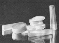 FIGURE 1. In 1965, magnesium fluoride laser optics manufactured by Optovac were subjected to a rather crude test for durability: they were plunged from boiling water into an ice bath and 'showed only occasional cleavage' (top). Today, these laser optics can survive up to 800ºC. Several companies, including Corning Tropel (Rochester, NY) and Edmund Optics (Barrington, NJ), manufacture finished magnesium fluoride optics to support the laser optics industry (bottom), estimated to grow to $1.8 billion in North America by 2009. FIGURE 1. In 1965, magnesium fluoride laser optics manufactured by Optovac were subjected to a rather crude test for durability: they were plunged from boiling water into an ice bath and 'showed only occasional cleavage' (top). Today, these laser optics can survive up to 800ºC. Several companies, including Corning Tropel (Rochester, NY) and Edmund Optics (Barrington, NJ), manufacture finished magnesium fluoride optics to support the laser optics industry (bottom), estimated to grow to $1.8 billion in North America by 2009.