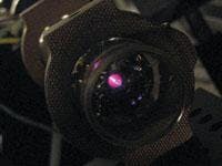 FIGURE 6. Potassium vapor in a cell is probed by ultrafast laser pulses to uncover the detailed dynamics of atomic collisions. The glowing comet-like shape seen through the entrance window of the cell is actually the atoms being excited by the pulses. FIGURE 6. Potassium vapor in a cell is probed by ultrafast laser pulses to uncover the detailed dynamics of atomic collisions. The glowing comet-like shape seen through the entrance window of the cell is actually the atoms being excited by the pulses.