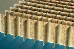 FIGURE 3. An array of split-ring resonators is used to demonstrate negative index at microwave frequencies. The rings are deposited on printed-circuit board; behind each ring is a straight-line conductor that is also part of the array, but is not shown in this view. FIGURE 3. An array of split-ring resonators is used to demonstrate negative index at microwave frequencies. The rings are deposited on printed-circuit board; behind each ring is a straight-line conductor that is also part of the array, but is not shown in this view.