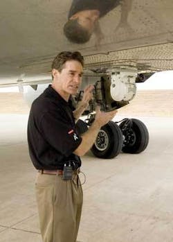 Burt Keirstead, BAE Systems Counter-MANPADS (man-portable air-defense systems) program director, stands next to BAE’s aircraft missile-defense system after its first flight test at Alliance Field (Fort Worth, TX) on Nov. 10, 2005.