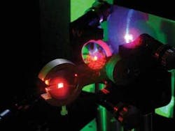 A frequency-doubled red-emitting VECSEL cavity produces tunable UV light (UV light appears bluish). A frequency-doubled red-emitting VECSEL cavity produces tunable UV light (UV light appears bluish).