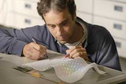 An engineer tests a prototype version of the array. An engineer tests a prototype version of the array.