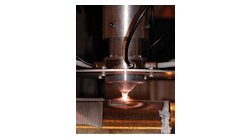 FIGURE 1. A new cladding process developed at the Fraunhofer Center for Surface and Laser Processing utilizes a 3 kW direct diode laser and a coaxial powder-feeding nozzle.