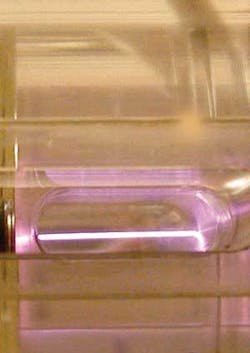 A 40 TW Ti:sapphire laser beam accelerates electrons in plasma within a capillary tube. A 40 TW Ti:sapphire laser beam accelerates electrons in plasma within a capillary tube.