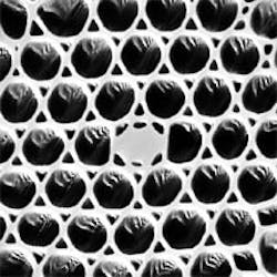 Ytterbium-doped holey fiber pumped with 966-nm light compresses and amplifies chirped 1.06-µm seed pulses. When in the holey fiber, the seed pulses quickly form solitons whose wavelength depends on the amount of amplifier gain. Wavelength tuning range of the setup is 1.06 to 1.33 µm. At higher pump powers, multicolor pulses are produced, some with wavelengths up to 1.58 µm. The solid core of the fiber, which carries the solitons, is approximately 2 µm in diameter. Ytterbium-doped holey fiber pumped with 966-nm light compresses and amplifies chirped 1.06-µm seed pulses. When in the holey fiber, the seed pulses quickly form solitons whose wavelength depends on the amount of amplifier gain. Wavelength tuning range of the setup is 1.06 to 1.33 µm. At higher pump powers, multicolor pulses are produced, some with wavelengths up to 1.58 µm. The solid core of the fiber, which carries the solitons, is approximately 2 µm in diameter.
