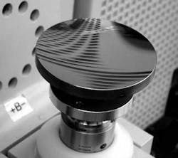 FIGURE 1. Aspheric subaperture-stitching interferometry can be used to measure the surface figures of aspheres such as this ellipsoid (conic), which has a 100 mm aperture diameter, a base radius of -226 mm, and approximately 12 µm of aspheric departure. The asphere is fabricated from lightweighted silicon carbide with silicon cladding. FIGURE 1. Aspheric subaperture-stitching interferometry can be used to measure the surface figures of aspheres such as this ellipsoid (conic), which has a 100 mm aperture diameter, a base radius of -226 mm, and approximately 12 µm of aspheric departure. The asphere is fabricated from lightweighted silicon carbide with silicon cladding.