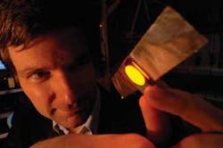 Ifor Samuel, a physics professor at the University of St. Andrews, has developed an OLED-based “sticking plaster” that simplifies the use of photodynamic therapy in the treatment of skin cancer. In the proof-of-principle prototype, the 2 cm polymer OLED light source is attached to the skin with standard medical tape. Ifor Samuel, a physics professor at the University of St. Andrews, has developed an OLED-based “sticking plaster” that simplifies the use of photodynamic therapy in the treatment of skin cancer. In the proof-of-principle prototype, the 2 cm polymer OLED light source is attached to the skin with standard medical tape.