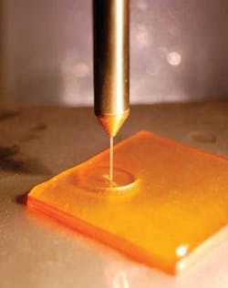 An abrasive-filled fluid jet polishes an optical surface in a predictable, controllable manner.