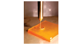 An abrasive-filled fluid jet polishes an optical surface in a predictable, controllable manner.