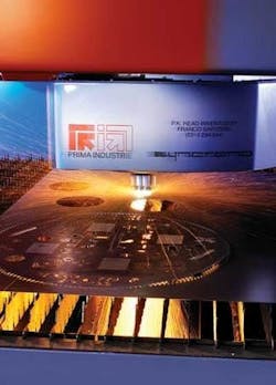 FIGURE 1. Prima Industrie in Italy builds a wide variety of 2‑D and 3-D carbon dioxide-based sheet-metal laser cutting machines. Its SYNCRONO product is an innovative machine for very fast and accurate cutting. With acceleration two times higher than benchmark machines, this system cuts more than a 1000 holes per minute while reaching an effective acceleration in excess of 6G. In this photo, an intricate pattern is being cut to show how the machine can process parts with complex trajectories with incredibly high dynamics. FIGURE 1. Prima Industrie in Italy builds a wide variety of 2‑D and 3-D carbon dioxide-based sheet-metal laser cutting machines. Its SYNCRONO product is an innovative machine for very fast and accurate cutting. With acceleration two times higher than benchmark machines, this system cuts more than a 1000 holes per minute while reaching an effective acceleration in excess of 6G. In this photo, an intricate pattern is being cut to show how the machine can process parts with complex trajectories with incredibly high dynamics.