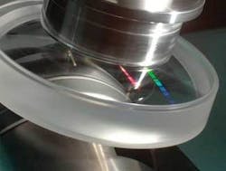 A single-point-diamond-turned asphere is polished via MRF (magnetorheological finishing). A new shape specification for axially symmetric aspheric surfaces promises to make optical design and fabrication of aspheres more straightforward. A single-point-diamond-turned asphere is polished via MRF (magnetorheological finishing). A new shape specification for axially symmetric aspheric surfaces promises to make optical design and fabrication of aspheres more straightforward.