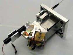 A fiber-coupled diode-laser module emits at 1.9 µm. The water-cooled module has two polarization-coupled bars and a green laser pointer to visually show the optical axis. A fiber-coupled diode-laser module emits at 1.9 µm. The water-cooled module has two polarization-coupled bars and a green laser pointer to visually show the optical axis.