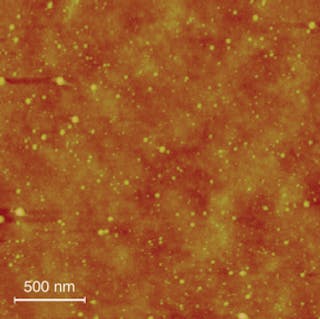 FIGURE 4. Because nanoparticles are formed during the laser-ablation process itself, the particles can be collected by any substrate material at room temperature. An atomic-force-microscopy (AFM) image shows nanoparticles uniformly dispersed on a transparent polymer substrate.