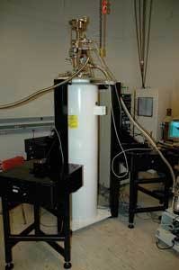 FIGURE 3. The Arizona State University dewar system sits on three Minus K negative-stiffness vibration-isolation systems. The black vertical structures are custom-built mechanical bars that ride on the isolators and support the dewar itself.