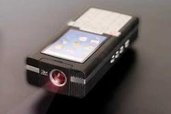 FIGURE 2. The Texas Instruments pico-projector contains a DLP chip-MEMS-based array-to project a two-dimensional display image. The display engine is small enough to fit within the confines of a compact disk, making it ideally suited for incorporation into mobile devices such as cell phones. FIGURE 2. The Texas Instruments pico-projector contains a DLP chip-MEMS-based array-to project a two-dimensional display image. The display engine is small enough to fit within the confines of a compact disk, making it ideally suited for incorporation into mobile devices such as cell phones.