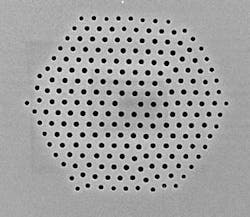 FIGURE 1. A silica microstructured optical fiber fabricated at the University of Southampton Optoelectronics Research Centre demonstrates the flexibility of sizes and arrangement of holes that can be fabricated in a single fiber. FIGURE 1. A silica microstructured optical fiber fabricated at the University of Southampton Optoelectronics Research Centre demonstrates the flexibility of sizes and arrangement of holes that can be fabricated in a single fiber.