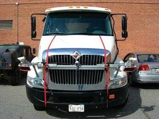 The NIST measurement system is strapped on the hood of a truck to test the crash warning system hidden inside the grill and windshield. The laser scanners are housed in the circular, red enclosures at the corners.