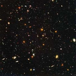 FIGURE 4. The Hubble Ultra Deep Field includes a view of nearly 10,000 galaxies. The smallest, reddest galaxies may be among the most distant known, existing when the universe was just about 800 million years old. The nearest galaxies - the larger, brighter, well-defined spirals and ellipticals - thrived about 1 billion years ago, when the cosmos was 13 billion years old. The image required 800 exposures taken over the course of 400 Hubble orbits around Earth. FIGURE 4. The Hubble Ultra Deep Field includes a view of nearly 10,000 galaxies. The smallest, reddest galaxies may be among the most distant known, existing when the universe was just about 800 million years old. The nearest galaxies - the larger, brighter, well-defined spirals and ellipticals - thrived about 1 billion years ago, when the cosmos was 13 billion years old. The image required 800 exposures taken over the course of 400 Hubble orbits around Earth.