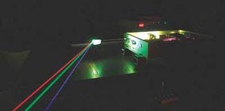 A Nd:YAG dual-wavelength oscillating laser with fundamental wavelengths at 1319 and 1064 nm is transformed into an RGB laser with oscillating emission of second-harmonic generated 660 nm (red) and 532 nm (green) light, as well as third-harmonic-generated 440 nm (blue) light from the 1319 nm fundamental wavelength. In effect, the quasi-white-light source is an oscillating RGB source.